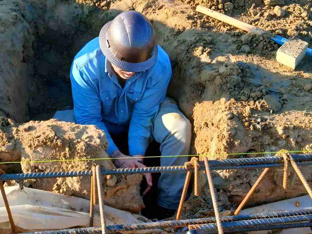 Legacy Plumbing Solutions technician working on a drain line installation in Claxton, GA. Local Service for drain lines, water heaters, water lines and drain cleaning.